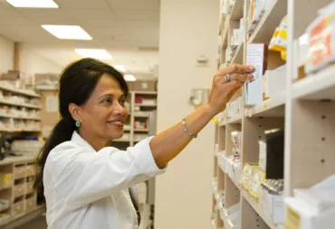 Pharmacist grabbing a pill bottle